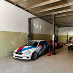 EE-C9 2 Post Car Hoist 4 Ton Clear Floor by Tufflift installed in a workshop, lifting bay ready for vehicle maintenance with race car in position