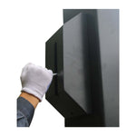 A gloved hand performs a maintenance check on the robust, black, metal column of a car hoist, ensuring the safety and stability of the lifting equipment. - 2 Post Baseplate Hoist - 4.5 Ton | EE-F10