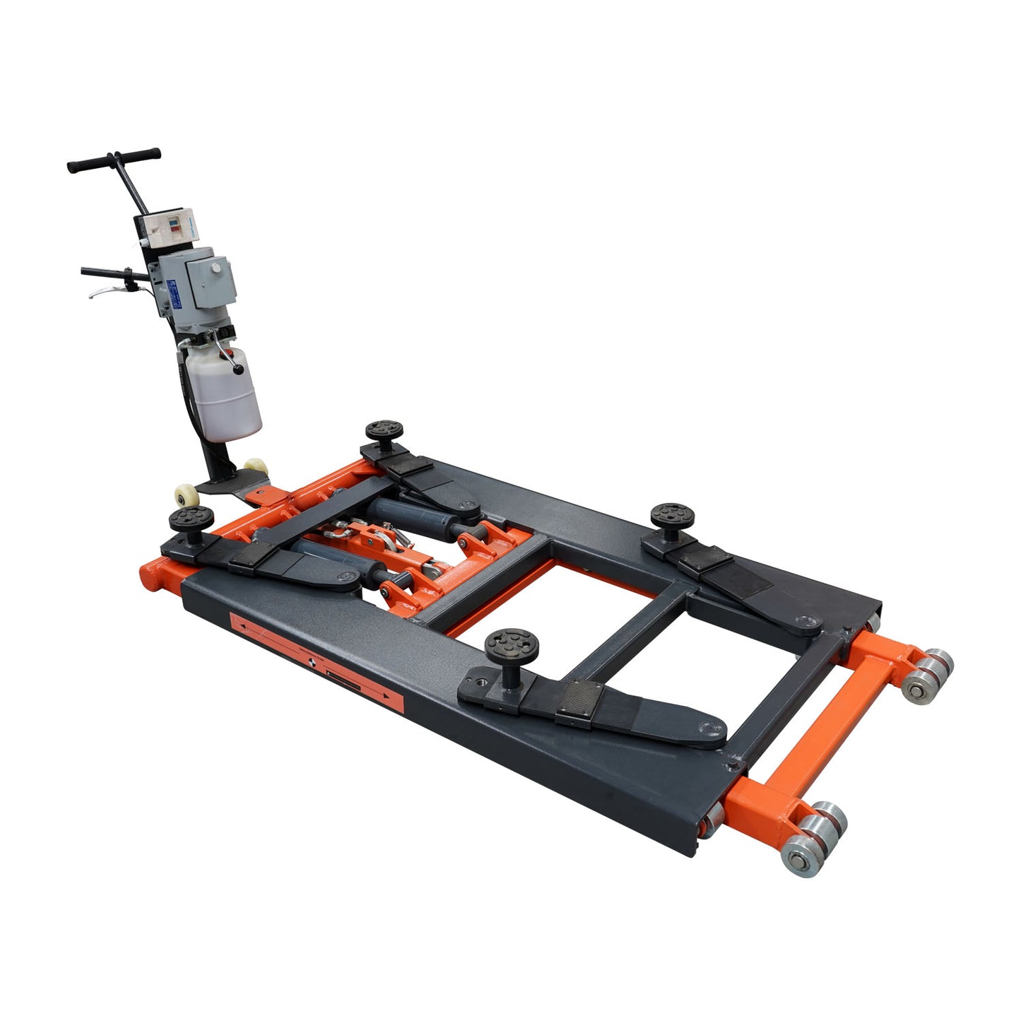 An orange and black EAE hydraulic scissor lift, model TS6600, in a fully lowered position on a workshop floor. The control unit with wiring is connected to the lift, showcasing its compact design.