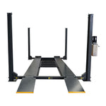 Front view of the 4 post car hoist model TL4.0PH in a workshop, showcasing the steel platform and diamond-plate ramps, ready for vehicle lifting or servicing.