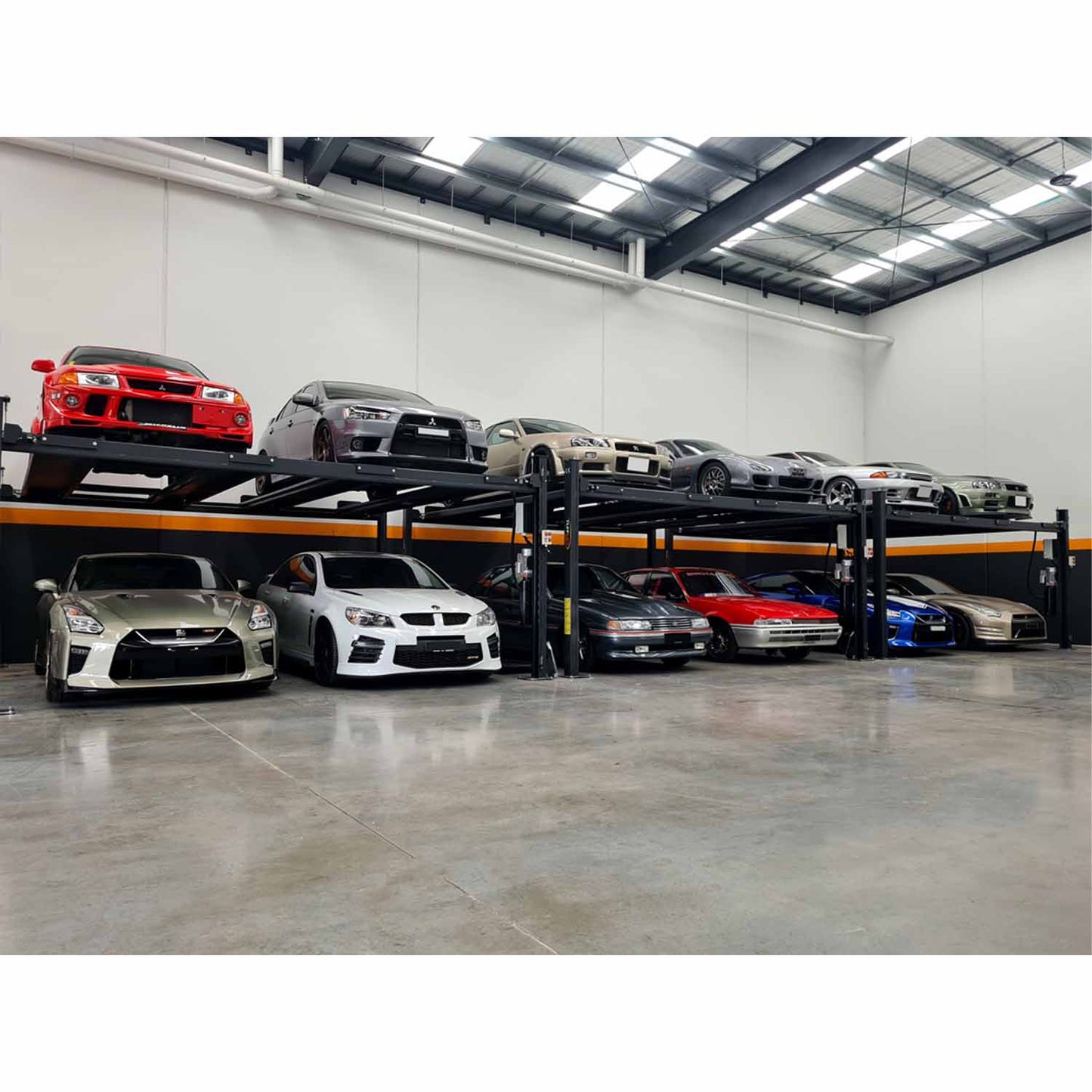 Indoor automotive storage facility with two levels of cars on four-post car lifts, showcasing various vehicles neatly parked in a spacious and well-organized environment. - 4 Post Twin Platform Parking Hoist – 4 Ton | TLD4.0TPL5.0M