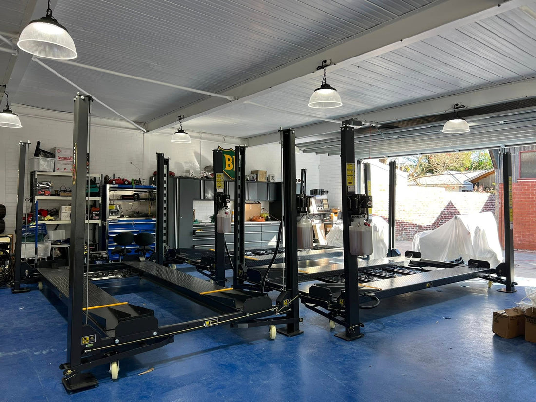 Shelves and storage racks arranged around a car hoist in a garage