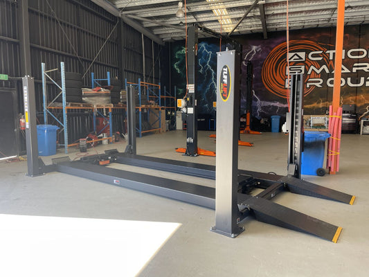  Mechanic inspecting a car hoist