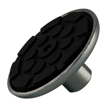 A close-up of a rubber pad with a textured black surface and a metal base, designed for stability and protection in vehicle lifting setups.