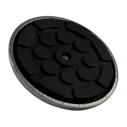 A top-down view of a rubber pad with a textured black surface, set within a metal frame.