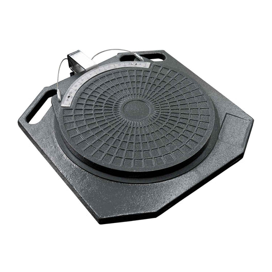 Close-up of a grey turntable alignment plate with a textured circular design and integrated degree measurement gauge, used for vehicle wheel alignment on a hoist.