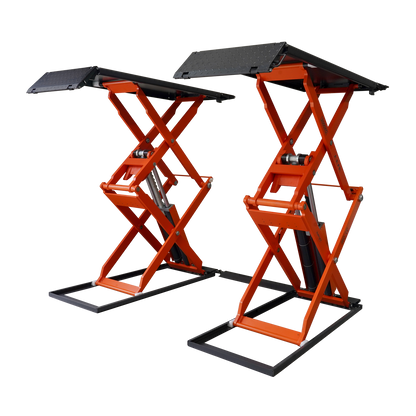 An orange scissor lift in a workshop, designed for lifting vehicles for maintenance and repairs. 