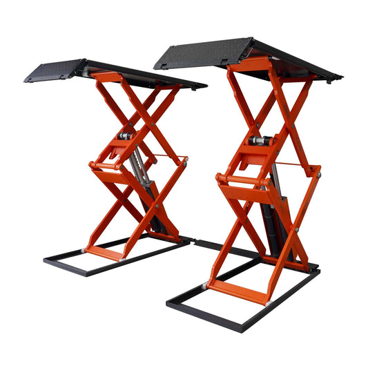An orange scissor lift in a workshop, designed for lifting vehicles for maintenance and repairs. 