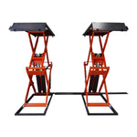 Front view of an orange scissor lifts in a workshop, designed for vehicle maintenance and lifting.