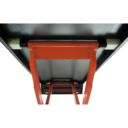 Close-up view of the underside of a scissor lift platform, showing the sturdy orange frame and support structure