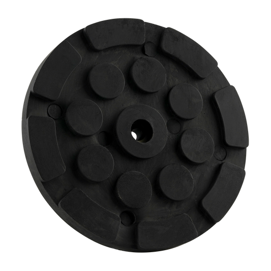 Black circular hoist pad with a central hole and raised sections, designed for use with car hoists to provide stability and grip.