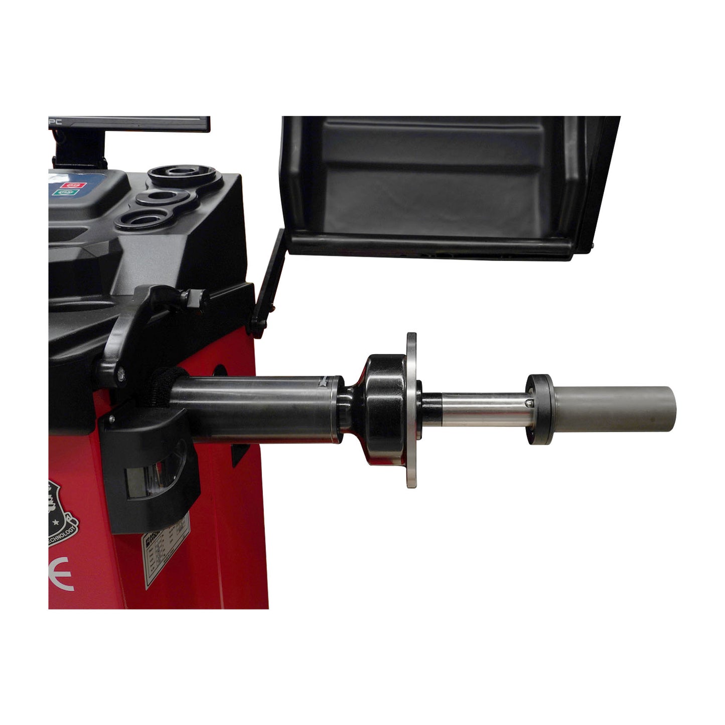 Close-up of SP833PL wheel balancer with wheel attached, focusing on shaft and clamping mechanism.