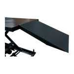 The image shows the loading ramp of the motorcycle hoist, made from diamond-patterned steel for enhanced traction. The ramp is securely attached to the platform, allowing easy motorcycle access to the lifting area.