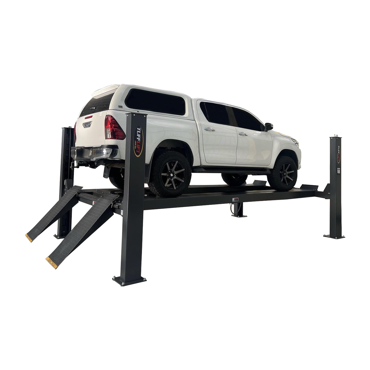 White SUV lifted on a four-post car hoist with drive-on ramps in an industrial garage, ready for maintenance and inspection. - 4 Post Workshop Hoist - 6 Ton | TL6.0PH