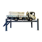 A heavy truck elevated on a four-post, eight ton workshop car hoist in a workshop setting. - 4 Post Wheel Alignment Hoist - 8.0 Ton | TLD8.0WA