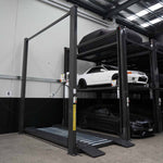 A robust four-post, three-tier parking lift with a durable dark grey frame, designed for maximizing vertical parking space and securely stacking vehicles across three levels. 4 Post Parking Hoist | Triple Stacker