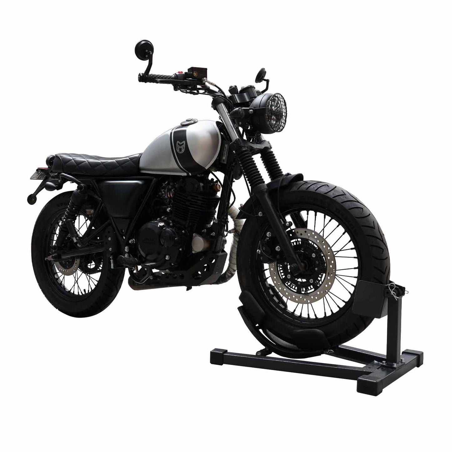 Motorcycle securely positioned in a wheel chock for stabilization in a workshop setting. - Motorcycle Wheel Chock | TLMCWC