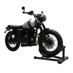 Motorcycle securely positioned in a wheel chock for stabilization in a workshop setting. - Motorcycle Wheel Chock | TLMCWC